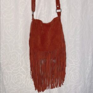 EARTHBOUND red suede leather long fringed crossbody handbag.